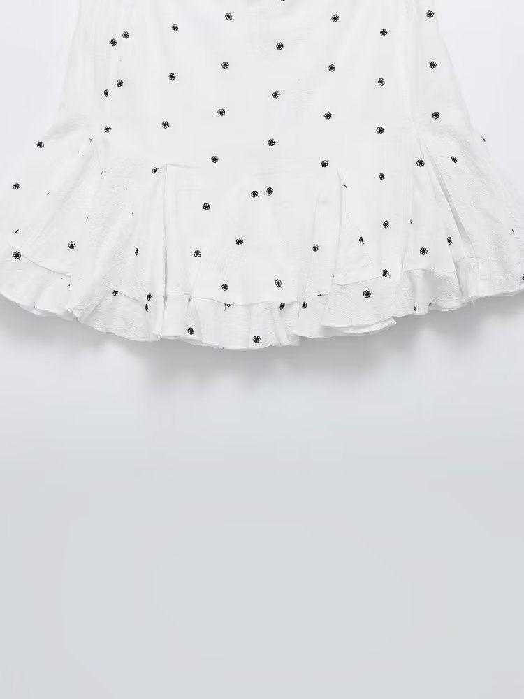 Floral pattern embroidered skirt with short A-line design in white.
