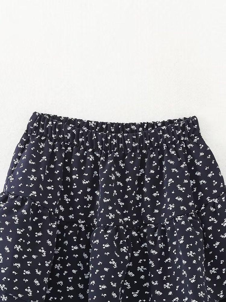 Elegant floral pattern skirt with a high rise, A-line tiered design, made of polyester.