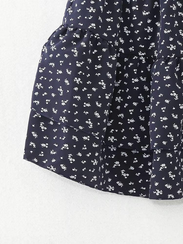 Elegant short floral pattern skirt with an A-line, tiered design, made from polyester, suitable for summer fashion.