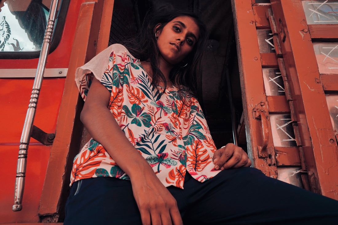woman wearing blue and red floral button-up T-shirt