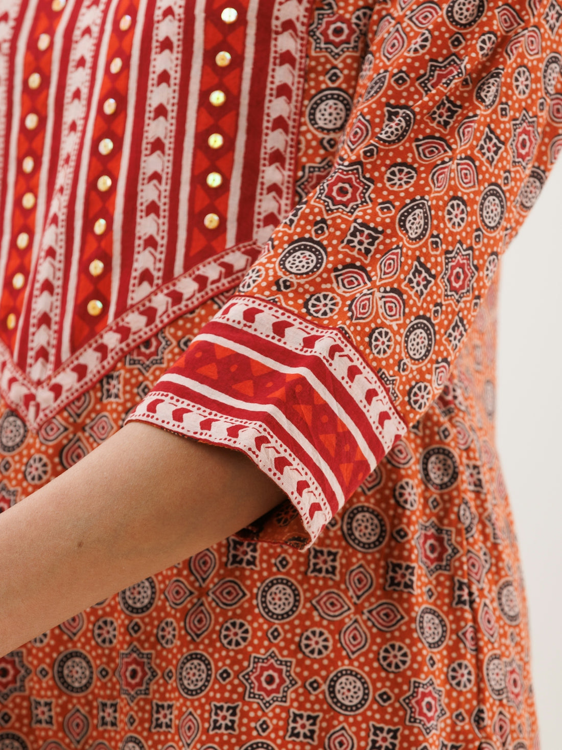 a close up of a person wearing a red and white dress