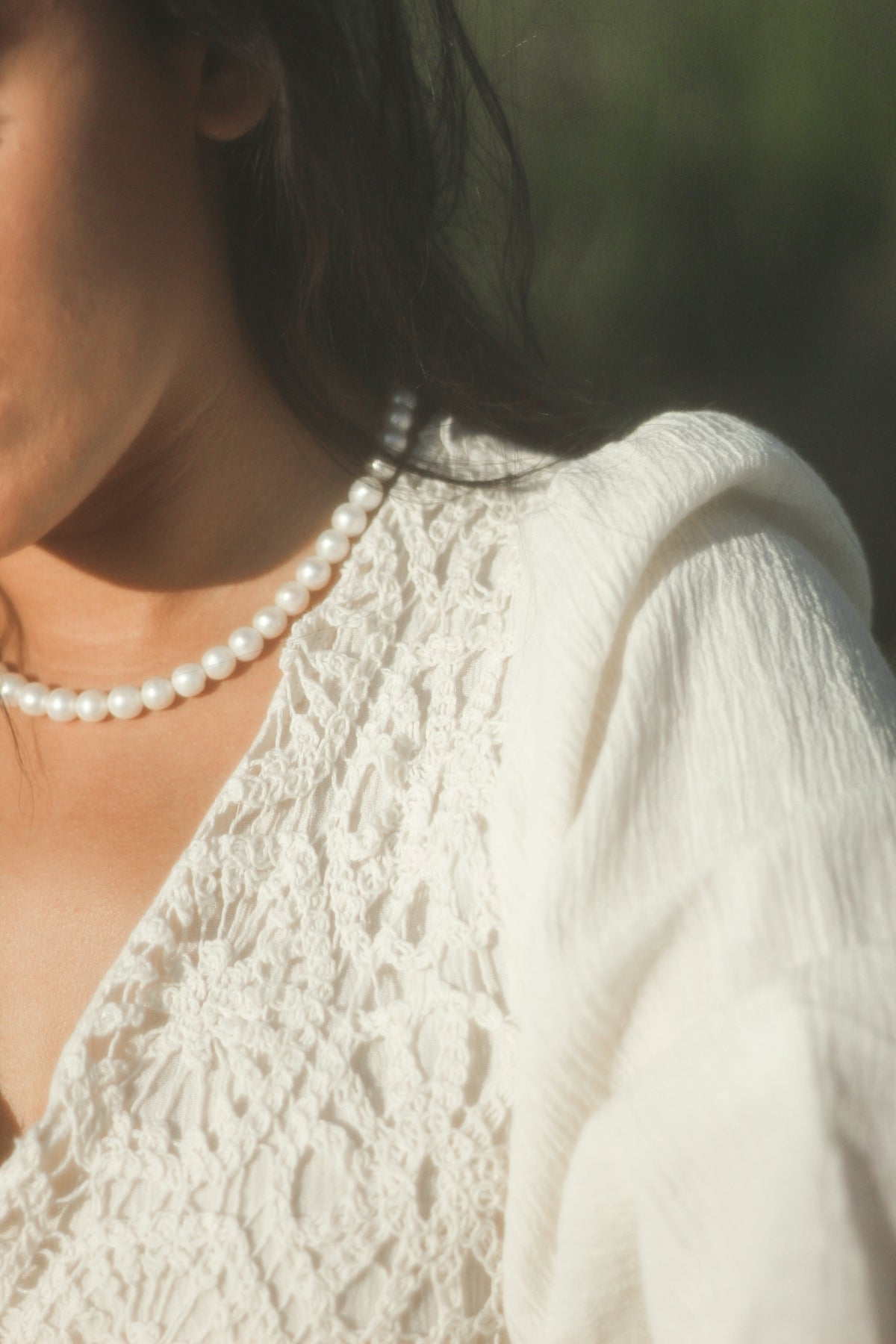 a woman in a white shirt is holding a cell phone