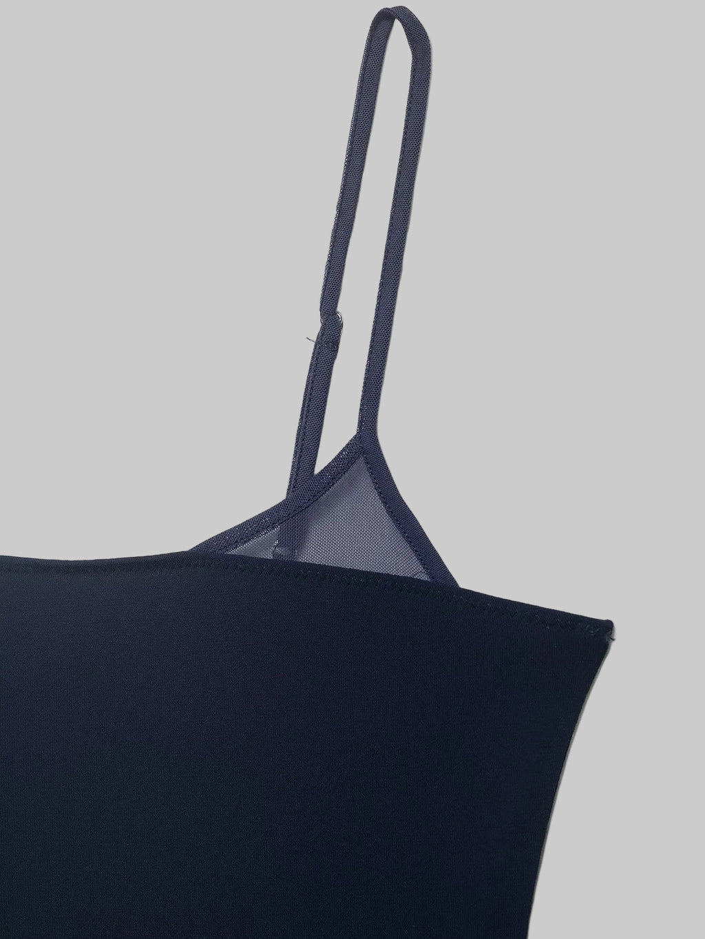 Navy blue top with thin straps on a white background