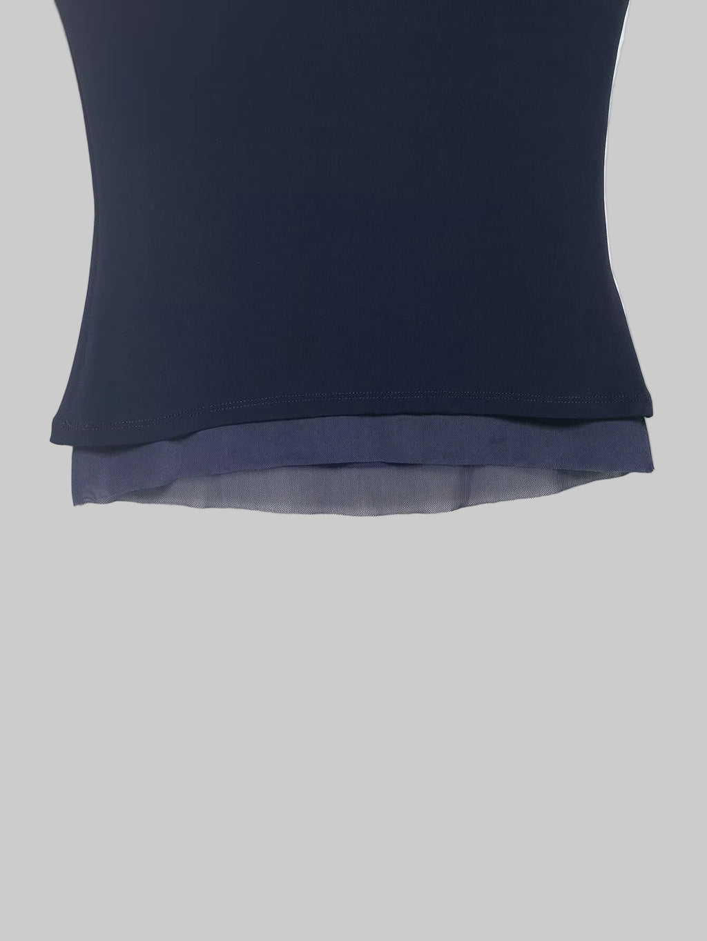 Navy blue top with sheer overlay on a white background