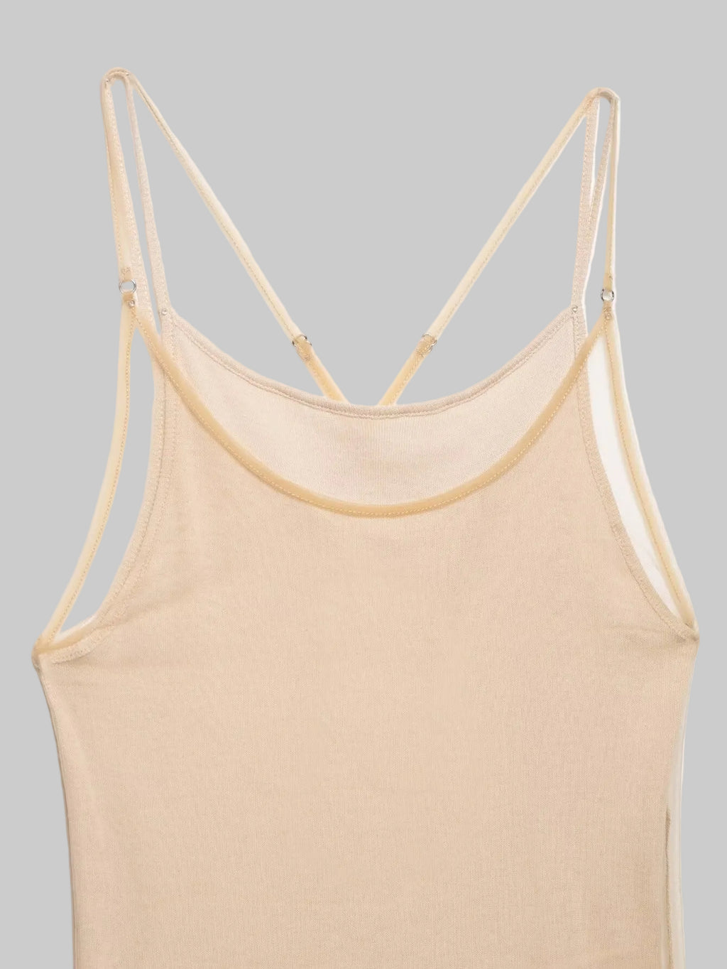 Beige tank top with thin straps on a white background