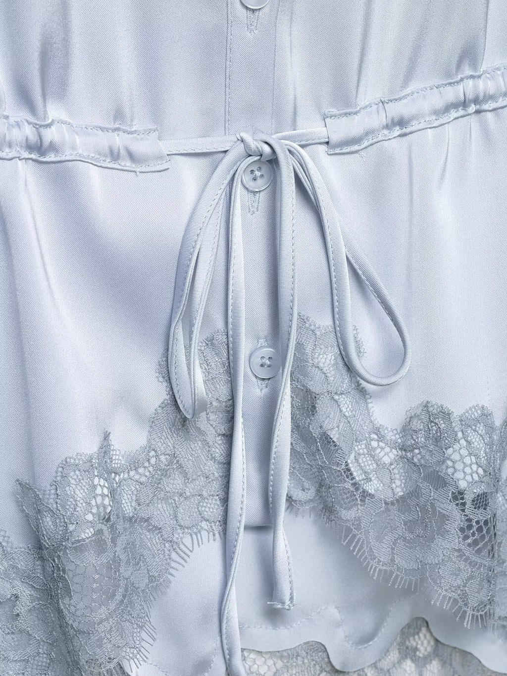 Light blue dress with lace details and a tie waist.