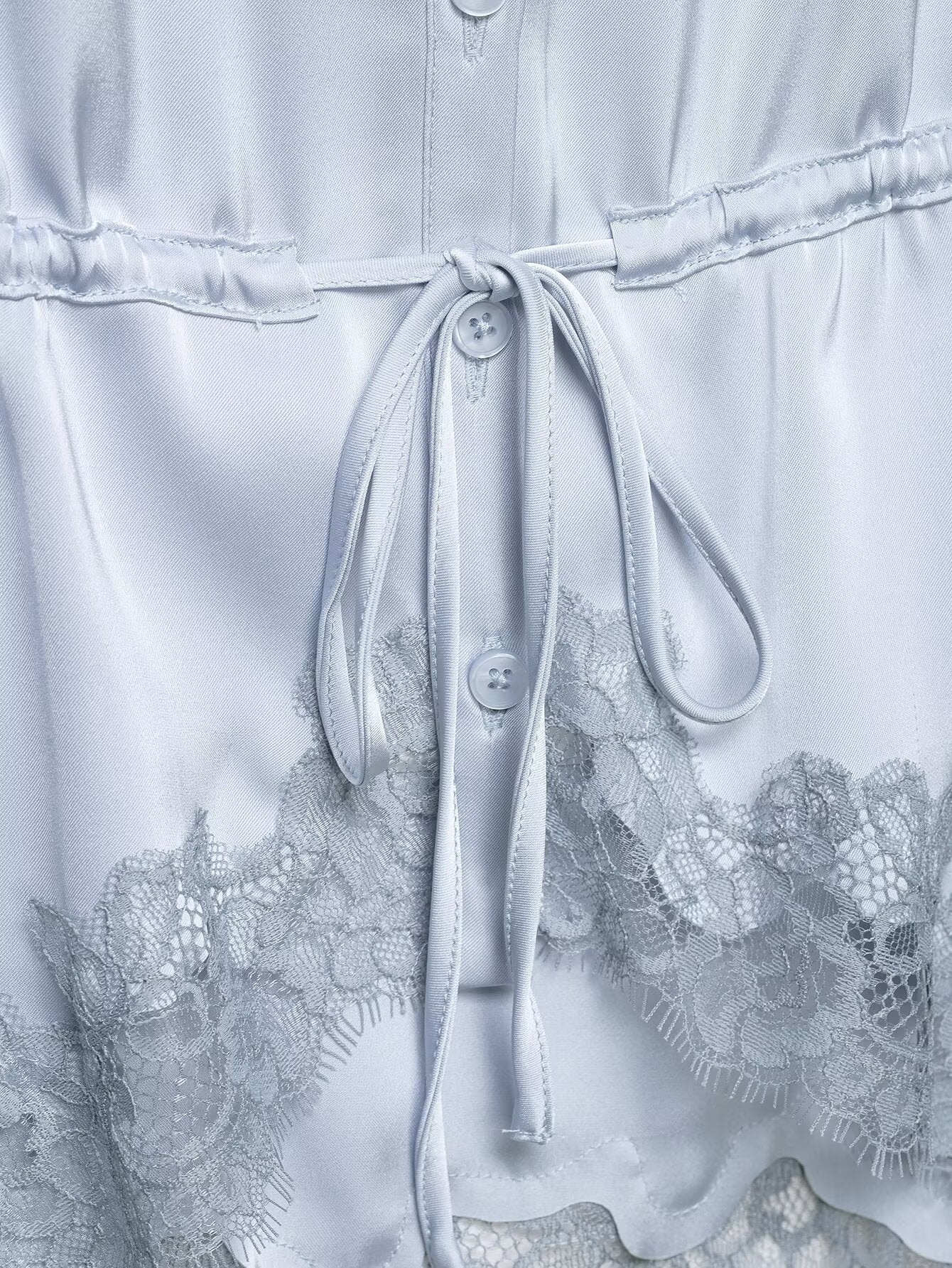 Light blue dress with lace details and a tie waist.