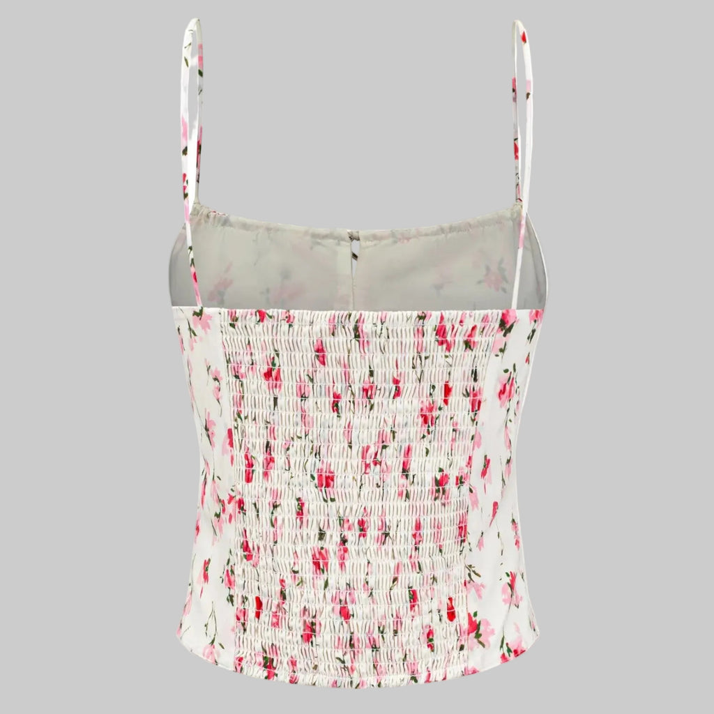 Floral patterned tank top with thin straps on a white background