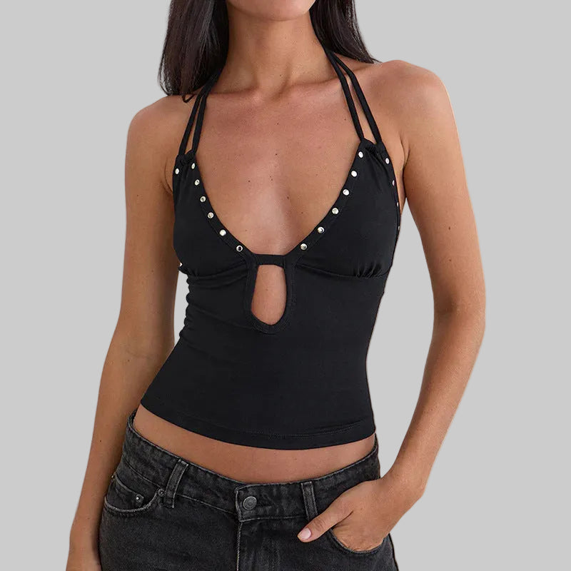 Black halter top with pearl embellishments on a plain background