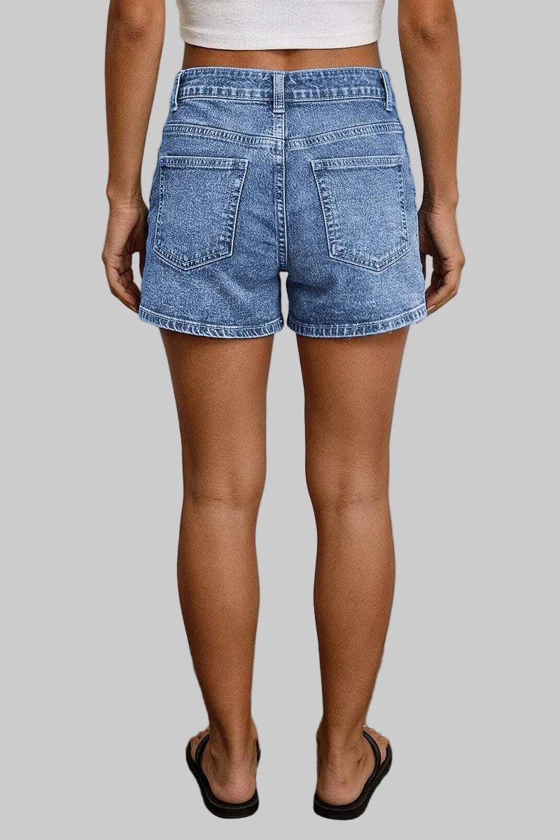 Person wearing blue denim shorts with a neutral background