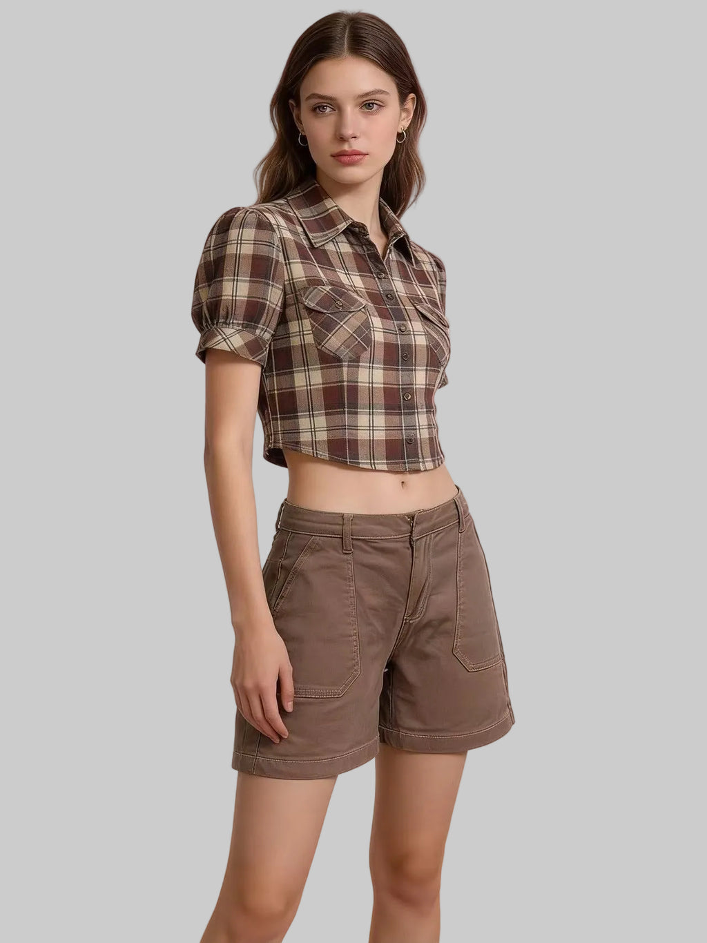 Woman wearing a plaid shirt and brown shorts on a gradient background