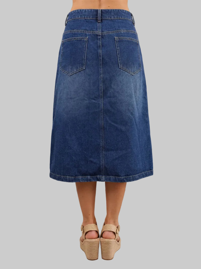 Blue denim skirt worn by a person on a white background