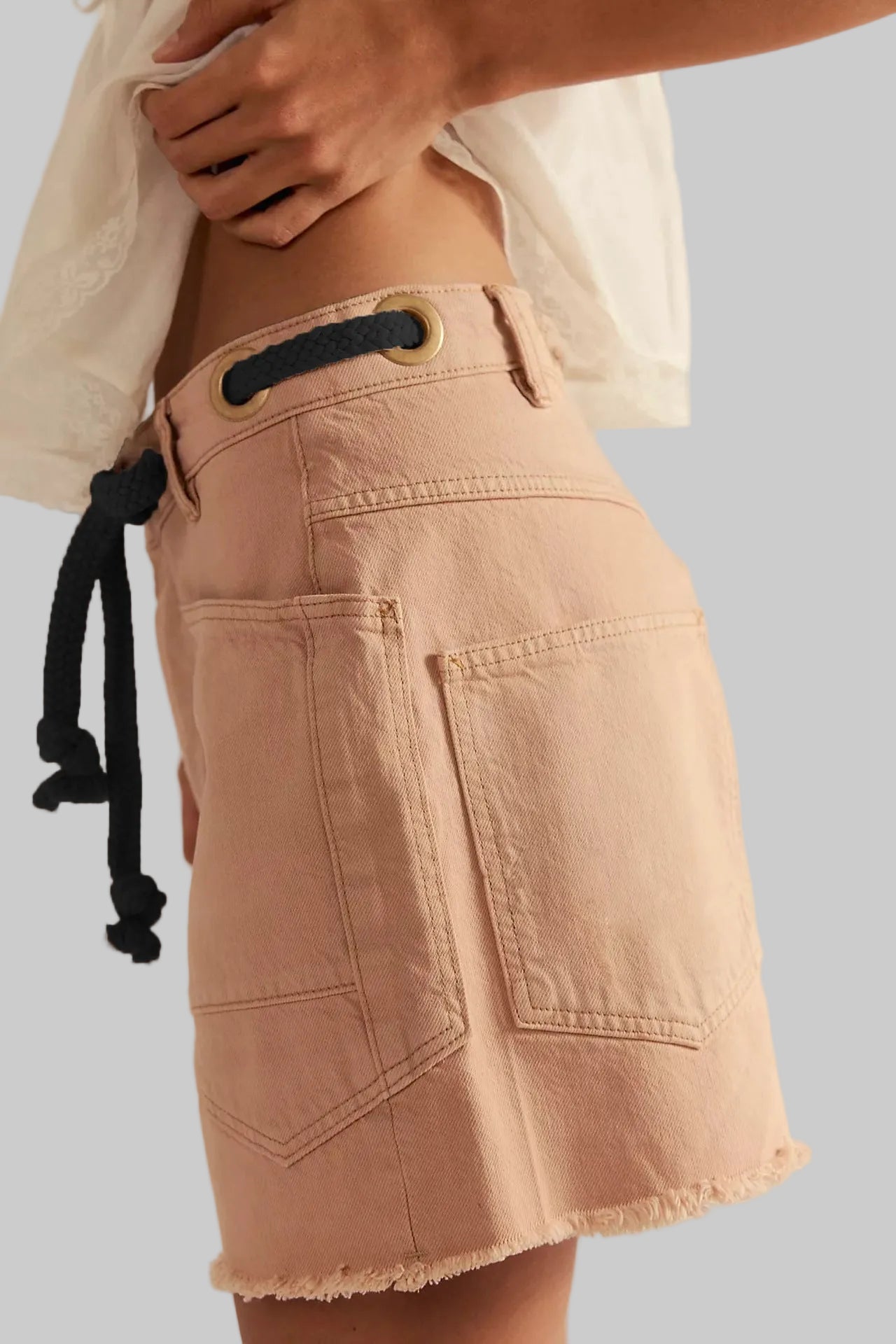 Beige skirt with black drawstring on a plain background
