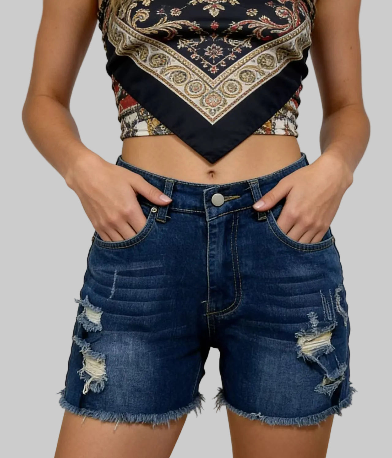 Person wearing a patterned crop top and denim shorts with a gradient background