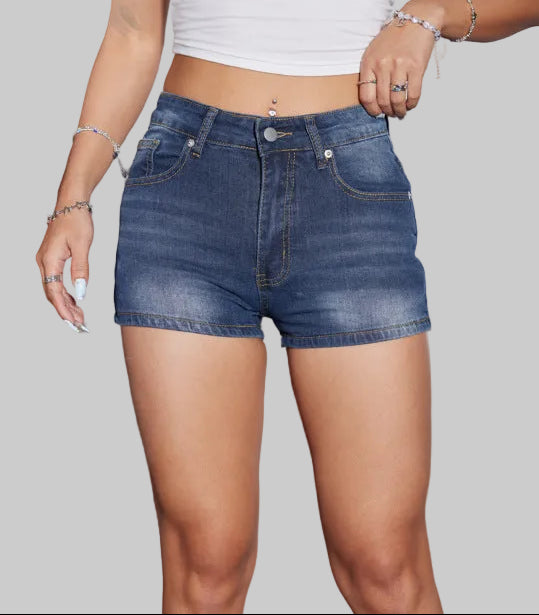 Person wearing a white crop top with 'Los Angeles 1998' text and blue denim shorts.