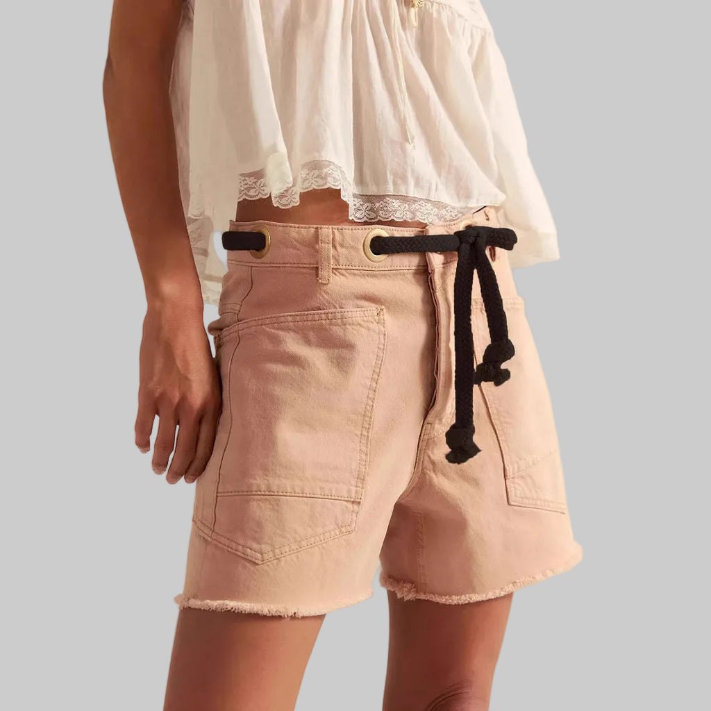Beige shorts with a black drawstring on a neutral background
