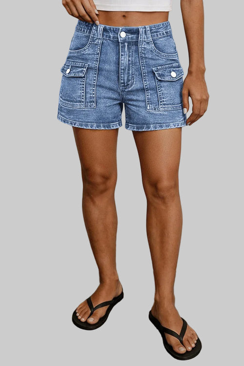 Person wearing blue denim shorts against a neutral background