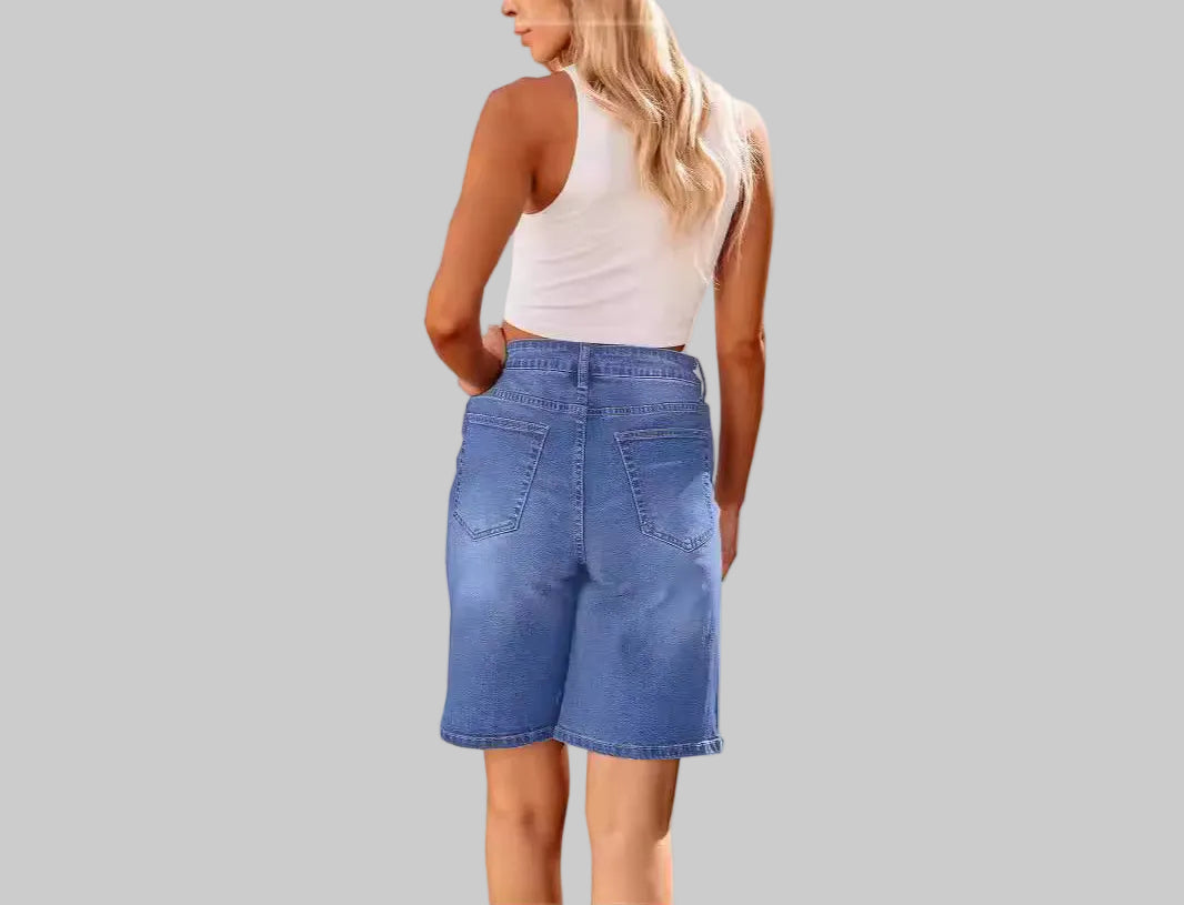 Woman wearing blue denim shorts on a white background