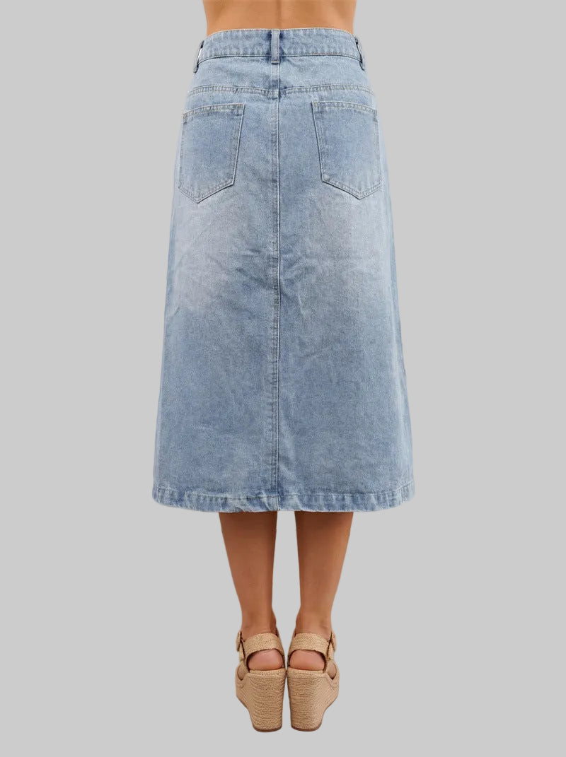 Denim skirt worn by a person in a minimal indoor setting