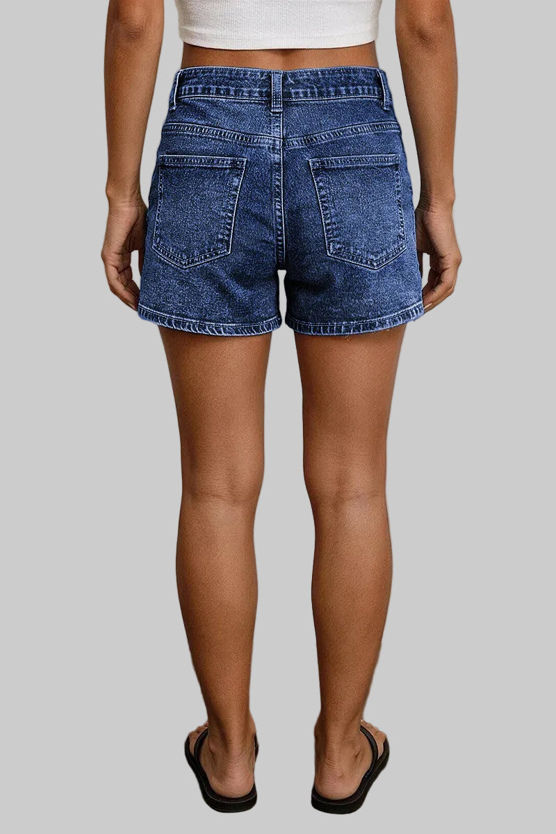 Person wearing blue denim shorts against a neutral background