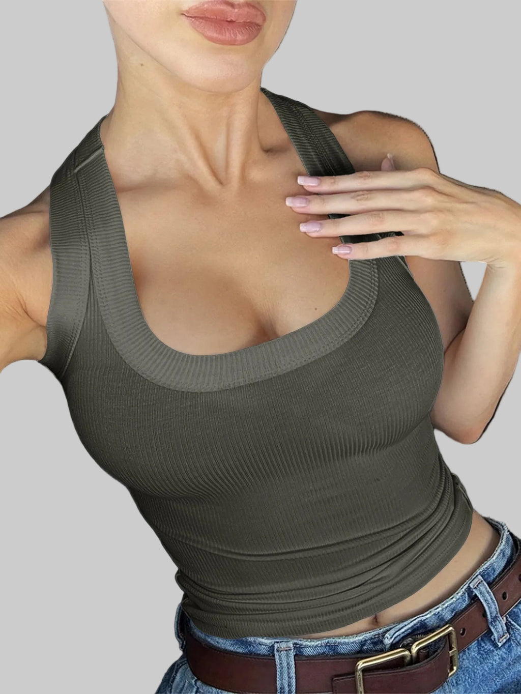 Woman wearing a brown tank top sitting in a car.