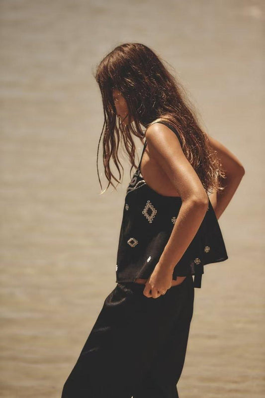 Spaghetti strap loose bow embroidered top in solid black cotton with boho style for summer.
